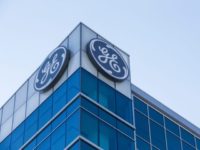 In this Jan. 16, 2018, file photo, the General Electric logo is displayed at the top of their Global Operations Center in the Banks development of downtown Cincinnati. General Electric is joining with Wabtec Corp. in a cash and stock deal as part of a move to help bolster its transportation unit. (AP Photo/John Minchillo, File) General Electric cuts $11B deal with Wabtec