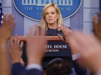 Journalist raise their hands to ask questions of Homeland Security Secretary Kirstjen duri