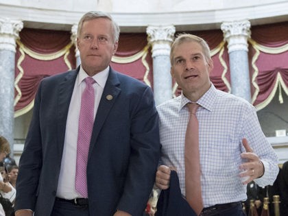 Rep. Mark Meadows, R-N.C., chairman of the conservative House Freedom Caucus, and Rep. Jim Jordan, R-Ohio, a key member of the group, walk through Statuary Hall at the Capitol in Washington, Wednesday, Sept. 13, 2017. With President Donald Trump wanting a legislative solution to replace the Deferred Action for Childhood …