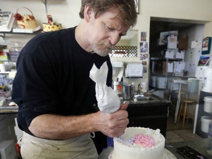 FILE - In this March 10, 2014, file photo, Masterpiece Cakeshop owner Jack Phillips decora
