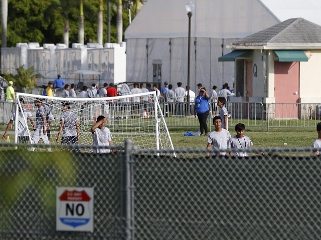 Immigrant children play outside a former Job Corps site that now houses them, Monday, June 18, 2018, in Homestead, Fla. It is not known if the children crossed the border as unaccompanied minors or were separated from family members. Wrenching scenes of migrant children being separated from their parents at …