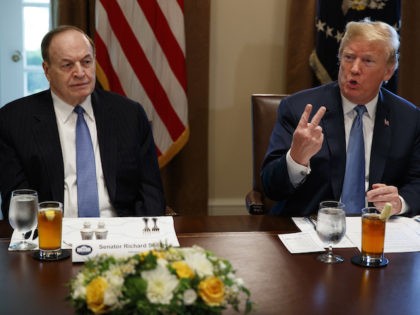 Sen. Richard Shelby, R-Ala., left, listens as President Donald Trump speaks during a meeti