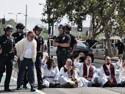 A member of clergy group, left, is arrested during a protest in front of Federal Courthous