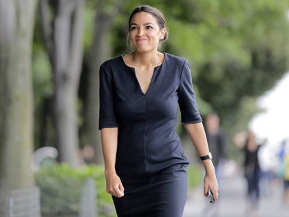 Alexandria Ocasio-Cortez smiles after taking a phone call in New York, Wednesday, June 27,