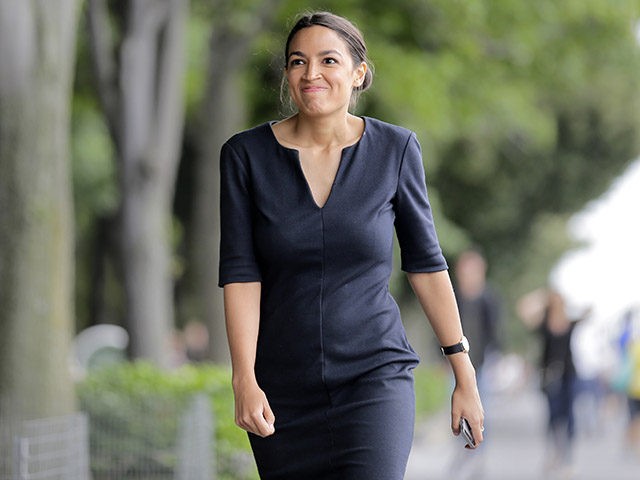 Alexandria Ocasio-Cortez smiles after taking a phone call in New York, Wednesday, June 27, 2018. The 28-year-old political newcomer who upset U.S. Rep. Joe Crowley in New York's Democrat primary says she brings an "urgency" to the fight for working families. (AP Photo/Seth Wenig)