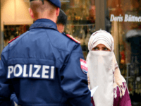 A police officer asks a woman to unveil her face in Zell am See, Austria, on October 1, 2017. Austria's ban on full-face Islamic veils comes into force following similar measures in other European countries. / AFP PHOTO / APA / BARBARA GINDL / Austria OUT (Photo credit should read …