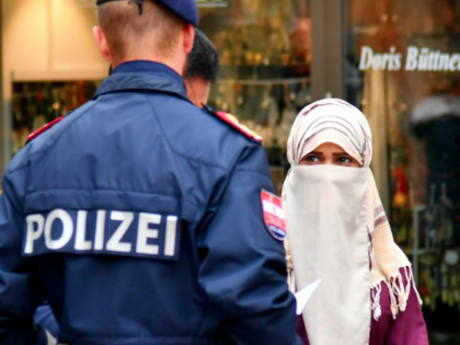 A police officer asks a woman to unveil her face in Zell am See, Austria, on October 1, 2017. Austria's ban on full-face Islamic veils comes into force following similar measures in other European countries. / AFP PHOTO / APA / BARBARA GINDL / Austria OUT (Photo credit should read …