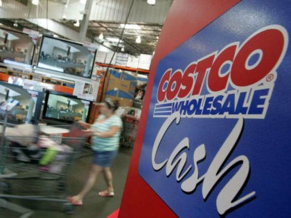 A Costco customer pushes her shopping cart by a display of televisions at a Costco warehouse store July 13, 2007 in Richmond, California. Costco Wholesale Corporation reported a six percent jump for June same store sales fueled by a spike in sales of televisions, jewelry, computers and groceries. (Photo by …