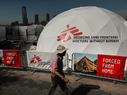 People walk by a traveling interactive exhibit organized by Doctors Without Borders (MSF)