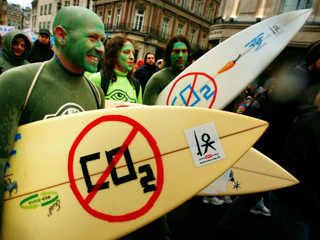 LONDON - DECEMBER 08: Climate change protestors carry surf boards near Trafalgar Square on December 8, 2007 in London. Demonstrators are gathering in more than 50 countries around the world. The worldwide protests coincide with the UN Climate talks in Bali and are calling for urgent action from world leaders …