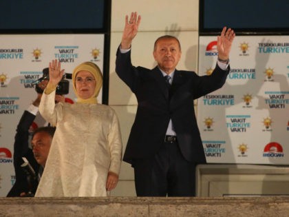 Turkey's President Recep Tayyip Erdogan and his wife Emine Erdogan greet supporters gather