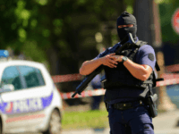 Anti-riot police officers patrol the Champs-Elysees avenue on June 19, 2017 on the Champs-Elysees avenue in Paris, after a car crashed into a police van before bursting into flames, with the driver being armed, probe sources said. A source close to the investigation said the driver was 'seriously injured'. / …