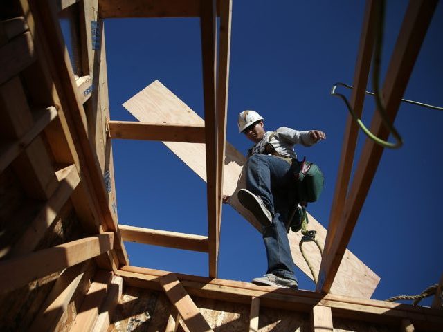 PETALUMA, CA - JANUARY 21: A worker carries lumber as he builds a new home on January 21, 2015 in Petaluma, California. According to a Commerce Department report, construction of new homes increased 4.4 percent in December, pushing building of new homes to the highest level in nine years. (Photo …
