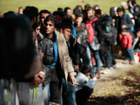 PASSAU, GERMANY - OCTOBER 28: German police lead arriving migrants alongside a street to a transport facility after gathering them at the border to Austria on October 28, 2015 near Wegscheid, Germany. Bavarian Governor Horst Seehofer has accused the Austrian government of wantonly shuttling migrants in buses from the Slovenian …