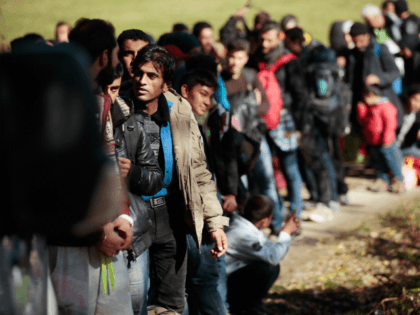 PASSAU, GERMANY - OCTOBER 28: German police lead arriving migrants alongside a street to a