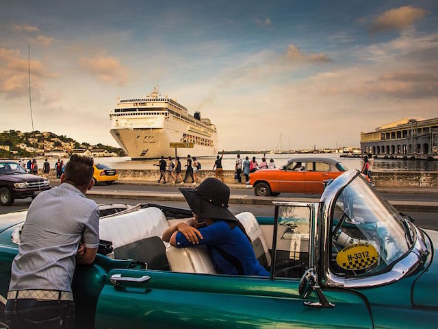 Cubans observe the arrival of a cruise ship bringing tourists to Havana, on January 18, 2017. / AFP / ADALBERTO ROQUE (Photo credit should read ADALBERTO ROQUE/AFP/Getty Images)