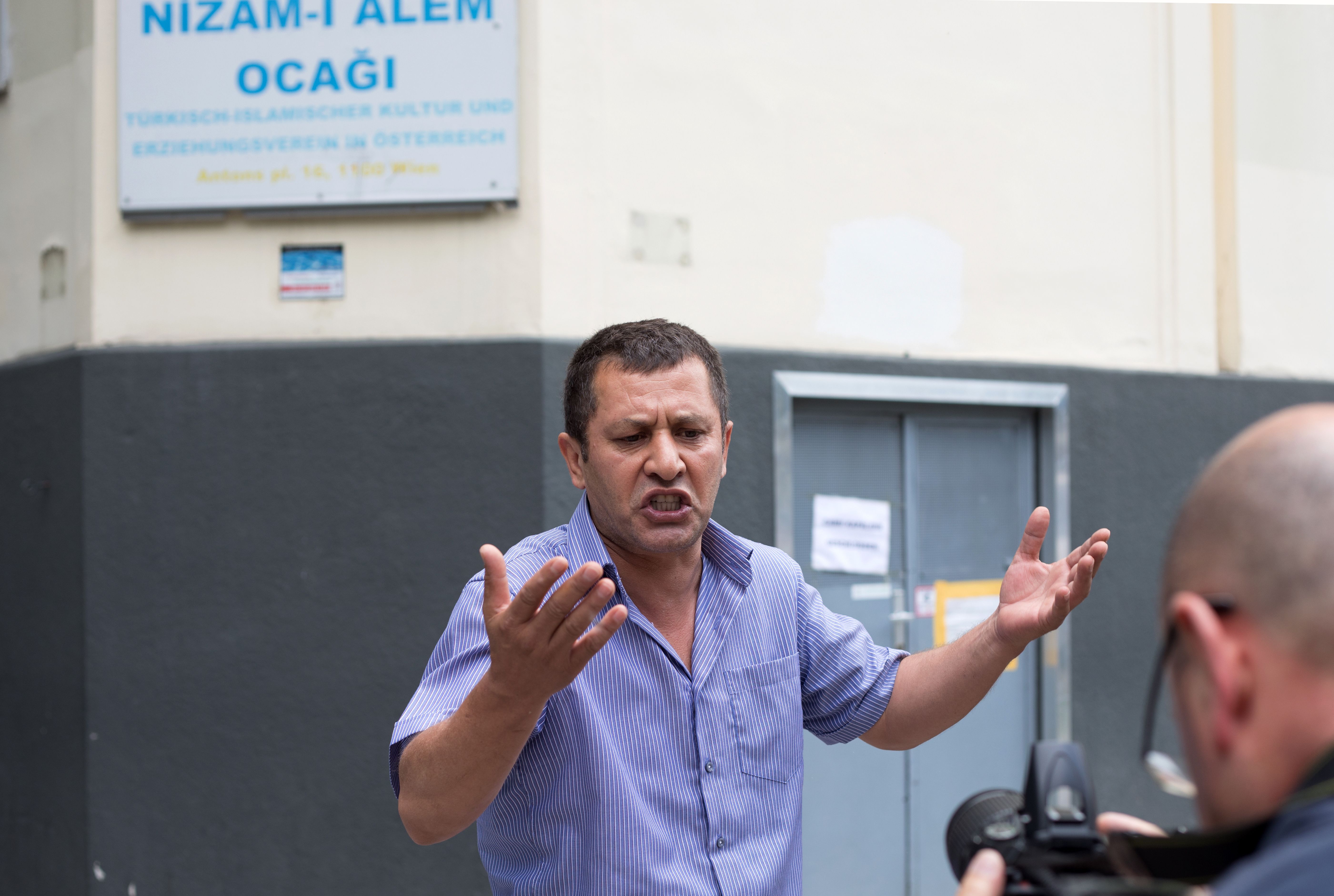 A community member gestures on June 8, 2018 in front of the "Nizam-i Alem" mosque in Vienna after it was closed as part of seven mosques that the Austrian government announced they would shut down. - Austria said on June 8, 2018 it could expel up to 60 Turkish-funded imams and their families and shut down seven mosques as part of a crackdown on "political Islam", triggering fury in Ankara. In total 150 people risked losing their right to residence, he said at a press conference in Vienna. (Photo by ALEX HALADA / AFP) (Photo credit should read ALEX HALADA/AFP/Getty Images)