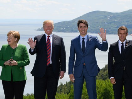 LA MALBAIE , QC - JUNE 08: German Chancellor Angela Merkel, US President Donald Trump, Canada's Prime Minister Justin Trudeau and , French President Emmanuel Macron wave during the Family photo on the first day of the G7 Summit, on 8 June, 2018 in La Malbaie, Canada. Canada will host …