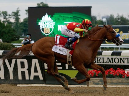 ELMONT, NY - JUNE 09: Justify #1, ridden by jockey Mike Smith leads the field to the finish line to win the 150th running of the Belmont Stakes at Belmont Park on June 9, 2018 in Elmont, New York. Justify becomes the thirteenth Triple Crown winner and the first since …