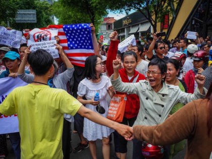 Vietnamese protesters shout slogans against a proposal to grant companies lengthy land lea