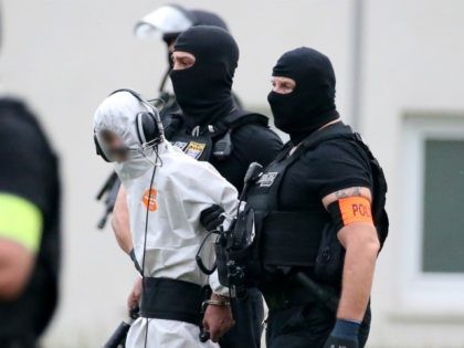Police officers of a special unit escort Iraqi asylum seeker Ali Bashar, who is suspected of having killed a German teenage girl, to a helicopter in Wiesbaden, western Germany, on June 10, 2018, heading to a prison after Bashar testified. - The 20-year-old man was brought back to Germany after …