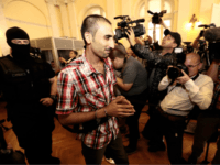 GettyImages-974112796 The main defendant Samsoor Lahoo (C) arrives for his trial on June 14, 2018 in Kecskemet, Hungary, where the court sentenced the four main defendants to 25 years in jail for the gruesome deaths of 71 migrants who suffocated in a lorry nearly three years ago. - The victims, 59 …