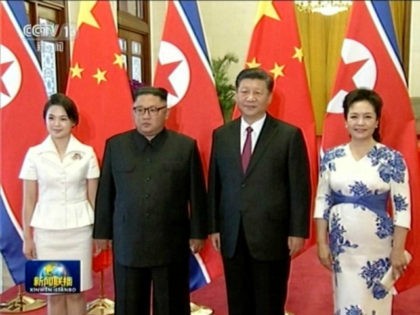 This image taken from China's CCTV on June 19, 2018, shows Chinese President Xi Jinping with his wife Peng Liyuan at right and North Korean leader Kim Jong Un with his wife Ri Sol-Ju at left during a welcome ceremony at the Great Hall of the People in Beijing. (CCTV …