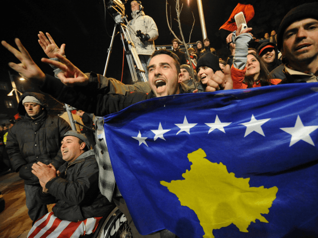 Kosovars celebrate the independence of Kosovo as they displays the contry's new flag in th