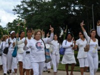 Ladies-in-White-cuba-getty Members of the Cuban Human Rights group Ladies in White make an 'L' (of liberation) with their fingers as they march along the 5th Avenue in Havana, on November 7, 2010. The march demanded Cuban President Raul Castro to complete the liberation of 52 political prisoners, which deadline was today. …