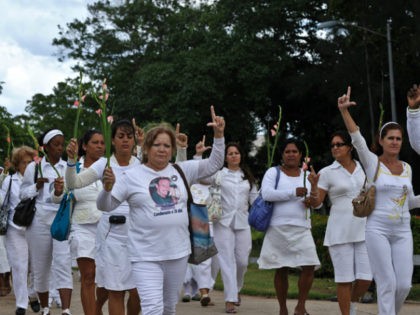 Members of the Cuban Human Rights group Ladies in White make an 'L' (of liberation) with their fingers as they march along the 5th Avenue in Havana, on November 7, 2010. The march demanded Cuban President Raul Castro to complete the liberation of 52 political prisoners, which deadline was today. …