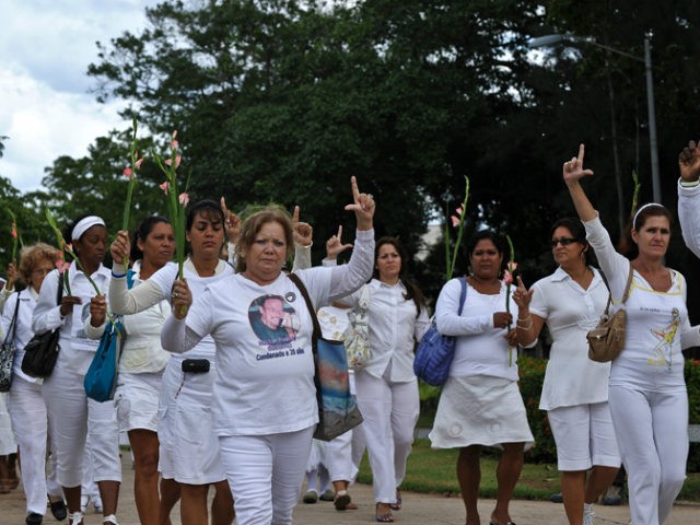 Members of the Cuban Human Rights group Ladies in White make an 'L' (of liberation) with t
