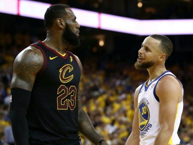 Stephen Curry #30 of the Golden State Warriors exchanges words with LeBron James #23 of th