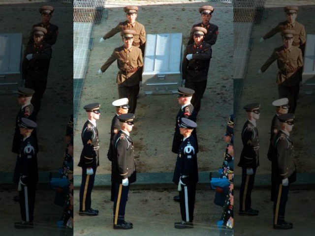 North Korean soldiers carry an aluminum casket containing remains of a U.S. serviceman kil