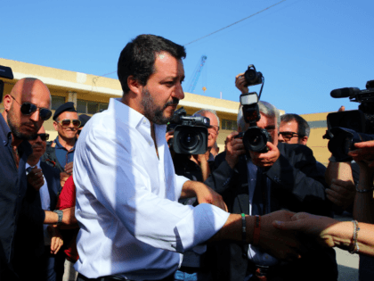 Italy's new hardline interior minister Matteo Salvini (C) arrives at the reception centre