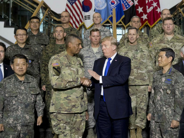 U.S. President Donald Trump, center, accompanied by United States Forces Korea Commander G