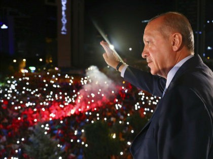 Turkey's President Recep Tayyip Erdogan, waves to supporters of his ruling Justice and Development Party (AKP) in Ankara, Turkey, early Monday, June 25, 2018. Erdogan won Turkey's landmark election Sunday, the country's electoral commission said, ushering in a new system granting the president sweeping new powers which critics say will …