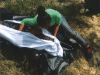 Victim 30 - Omar Mendez Perez - with daughter - body bag Cindy Vanessa Mendez kneels over her father's body. Omar Mendez Perez died after being left behind by human smugglers after he fell ill and was unable to keep up. (Photo: Brooks County Sheriff's Office)