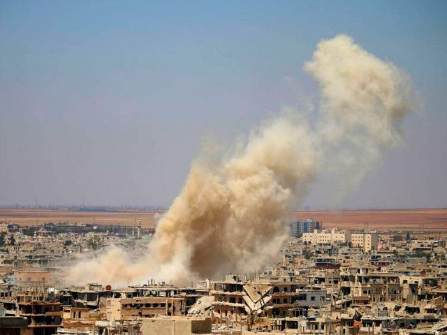 Smoke rises above opposition held areas of Daraa during an airstrike by Syrian regime forc