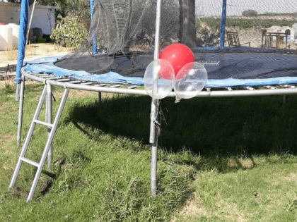 TEL AVIV - A bunch of balloons outfitted with an explosive device that was flown over from the Gaza Strip landed on a trampoline in the backyard of an Israeli family's home Wednesday, prompting a mother to instruct her children to stay away.  