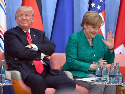 US President Donald Trump, left, and German Chancellor Angela Merkel attend the panel discussion "Launch Event Women's Entrepreneur Finance Initiative" on the second day of the G-20 summit in Hamburg, Germany, Saturday, July 8, 2017. (Patrik Stollarz/Pool Photo via AP)