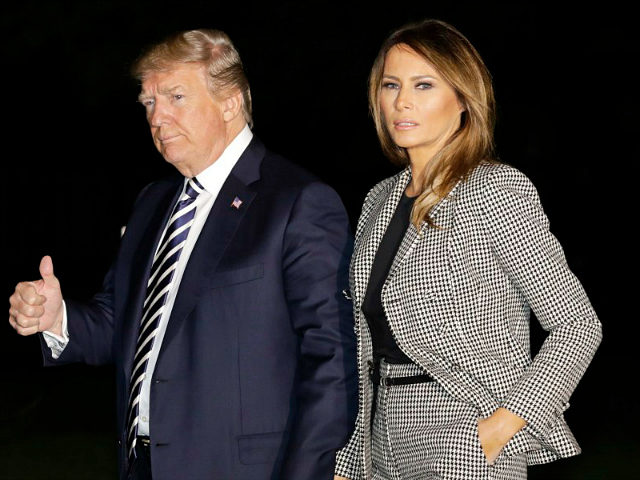 U.S. President Donald Trump, left, gives a thumbs-up as he walks with First Lady Melania T