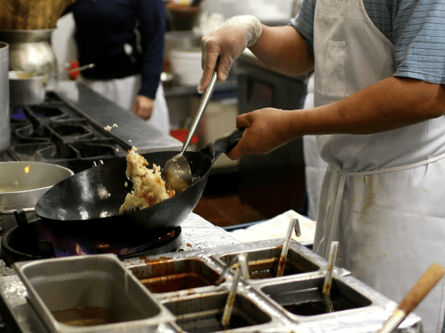 A cook prepares Thai fried rice in the kitchen at Osha Thai Restaurant May 5, 2008 in San Francisco, California. As rice prices continue to climb and some places are limiting the number of bags small businesses can purchase, many Bay Area restaurants are being forced to raise menu prices …