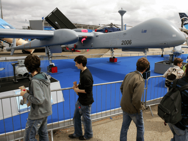 Visitors look at an Israel Aerospace Industries-made drone, Heron TP, on the last day of the 47th Paris Air Show in Le Bourget, north of Paris, Sunday June 24, 2007. The Heron TP is a medium altitude long endurance UAV system. (AP Photo/Remy de la Mauviniere)