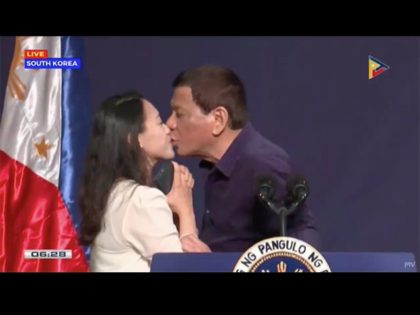 KISS ON THE LIPS. President Rodrigo Duterte kisses an overseas Filipino worker during his