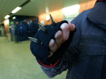 MUNICH, GERMANY - JANUARY 03: A young man shows his knuckle duster at the basement of Kieferngarten Underground Station on January 3, 2007 in Munich, Germany. After an elder man was attacked by juvenile criminals in a Munich Metro Station, Roland Koch, State Governor of Hessen and one of the …
