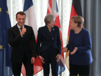 French President Emmanuel Macron, British Prime Minister Theresa May and German Chancellor Angela Merkel share a joke as they arrive for the start of an EU-Western Balkans Summit in Sofia on May 17, 2018. - European Union leaders will meet their Balkan counterparts to hold out the promise of closer …
