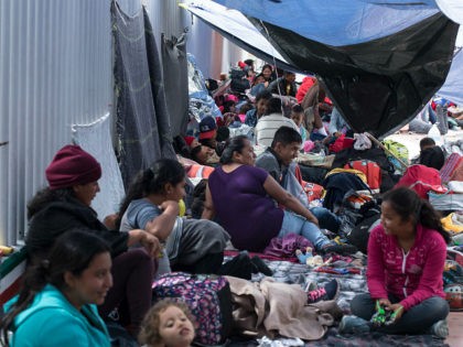 People who traveled with the annual caravan of Central American migrants, rest where the group set up camp to wait for access to request asylum in the US, outside the El Chaparral port of entry building at the US-Mexico border in Tijuana, Mexico, Monday, April 30, 2018. About 200 people …