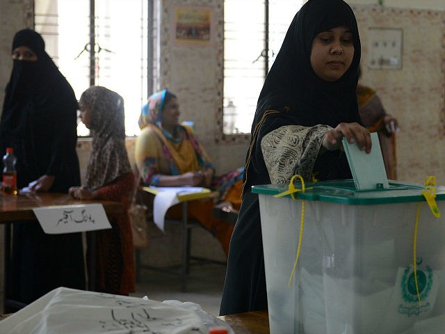 A Pakistani voter casts her ballot in a by-election in Lahore on September 17, 2017. The w