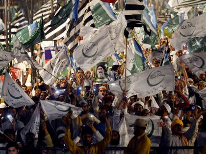 Supporters of Muttahida Majlis-e-Amal (MMA), a religious parties alliance waves flags duri