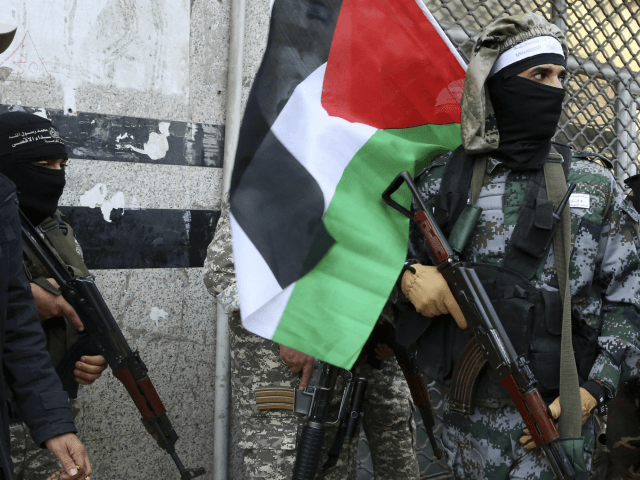 Masked militants from Al Aqsa Martyrs' Brigade, a militia linked to the Fatah movement, ho